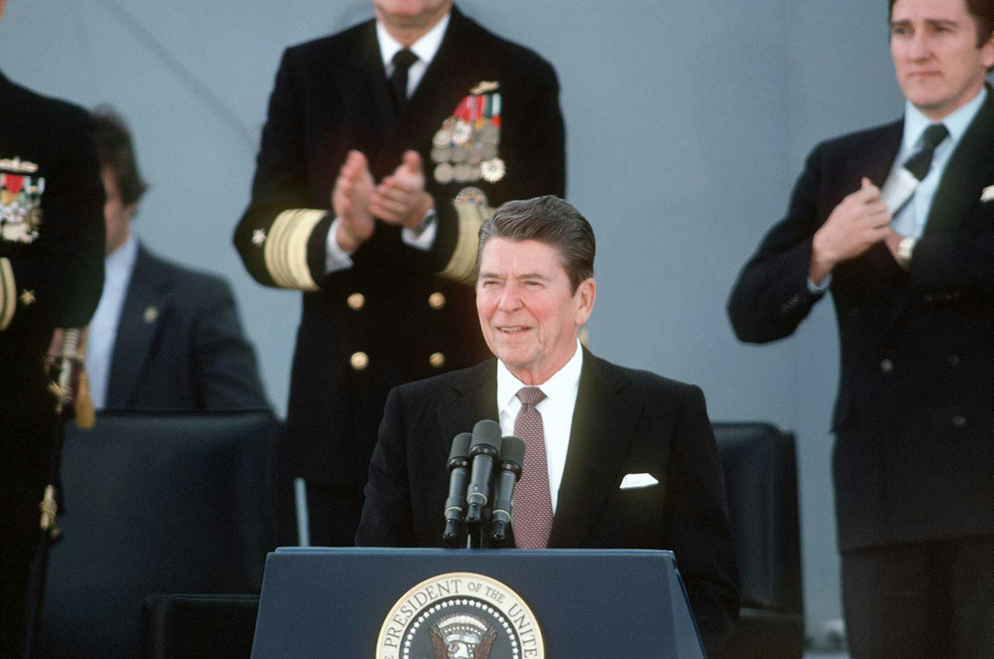 President Ronald Reagan, principal speaker, addresses the guests attending the recommissioning ceremony for the battleship USS NEW JERSEY, December 28, 1982. Alamy Stock Photo, KRWF97.