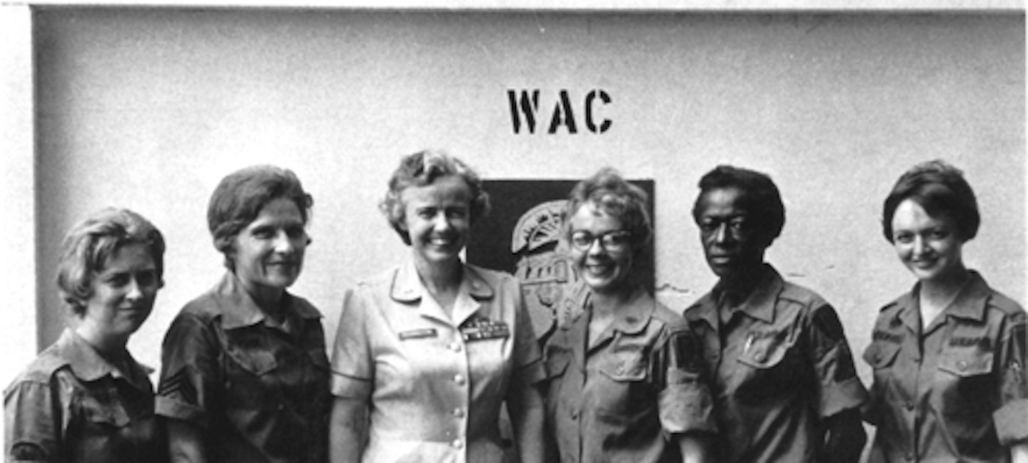 WACs wearing men's fatigues stand with Colonel Elizabeth Hoisington, WAC Director, 1963. Photo courtesy of the Women's Army and Historical Museum and Archives.