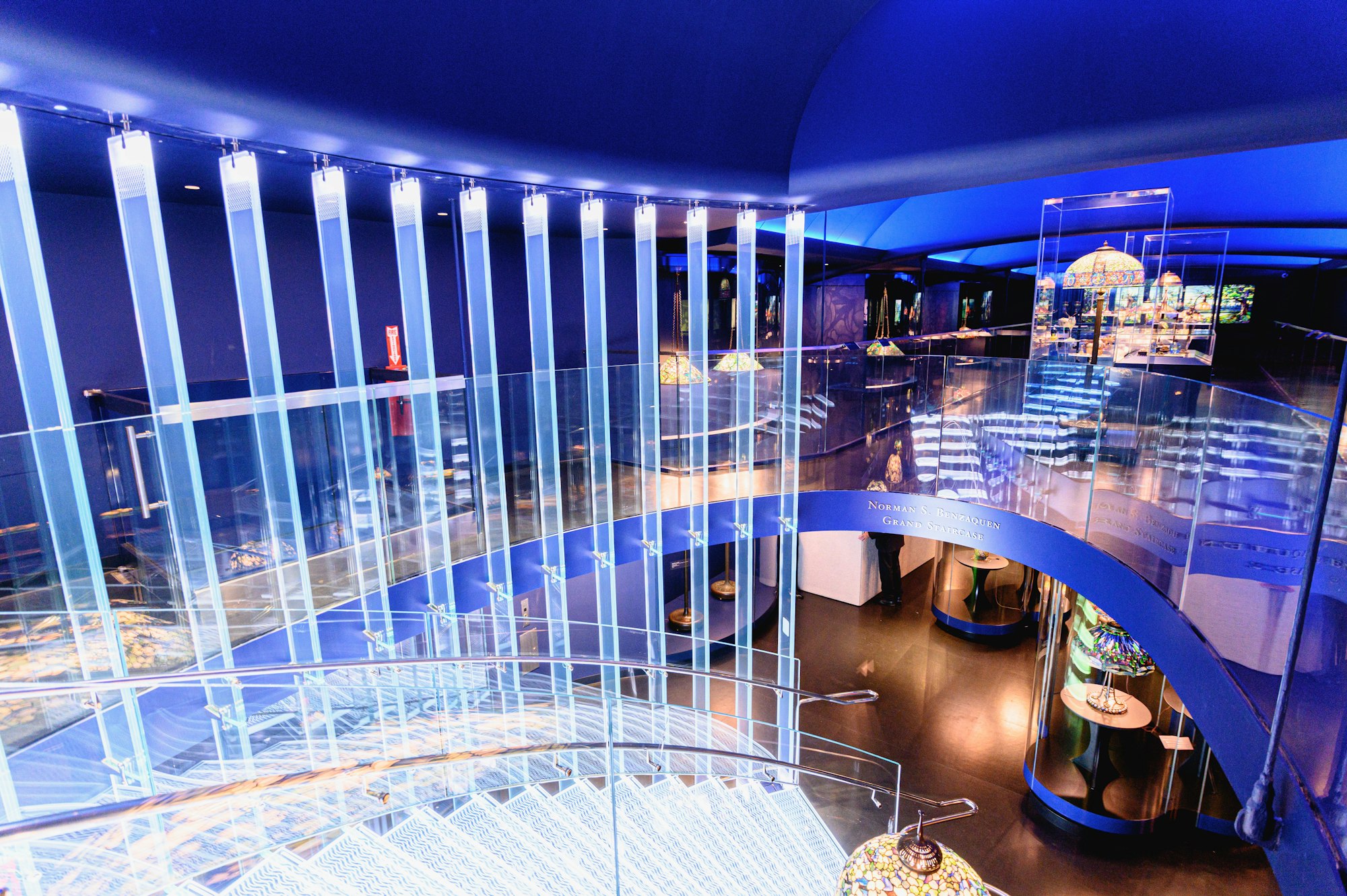 a shot of the Tiffany Gallery showing the lighted staircase and the lamps below