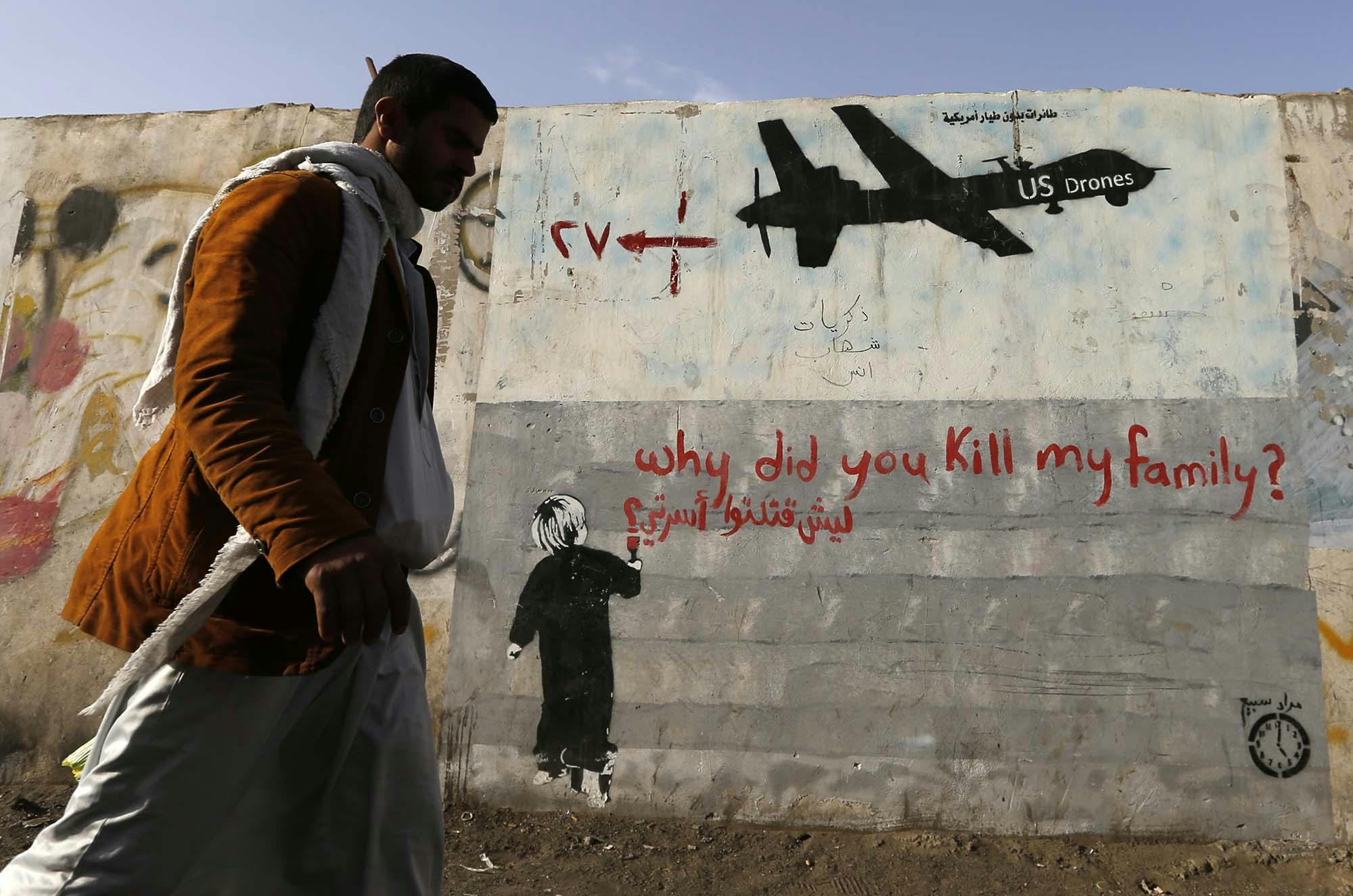 Photo, Khaled Abdullah Ali Al Mahdi, A man walks past a graffiti, denouncing strikes by U.S. drones in Yemen, painted on a wall in Sanaa, November 13, 2014. Reuters.