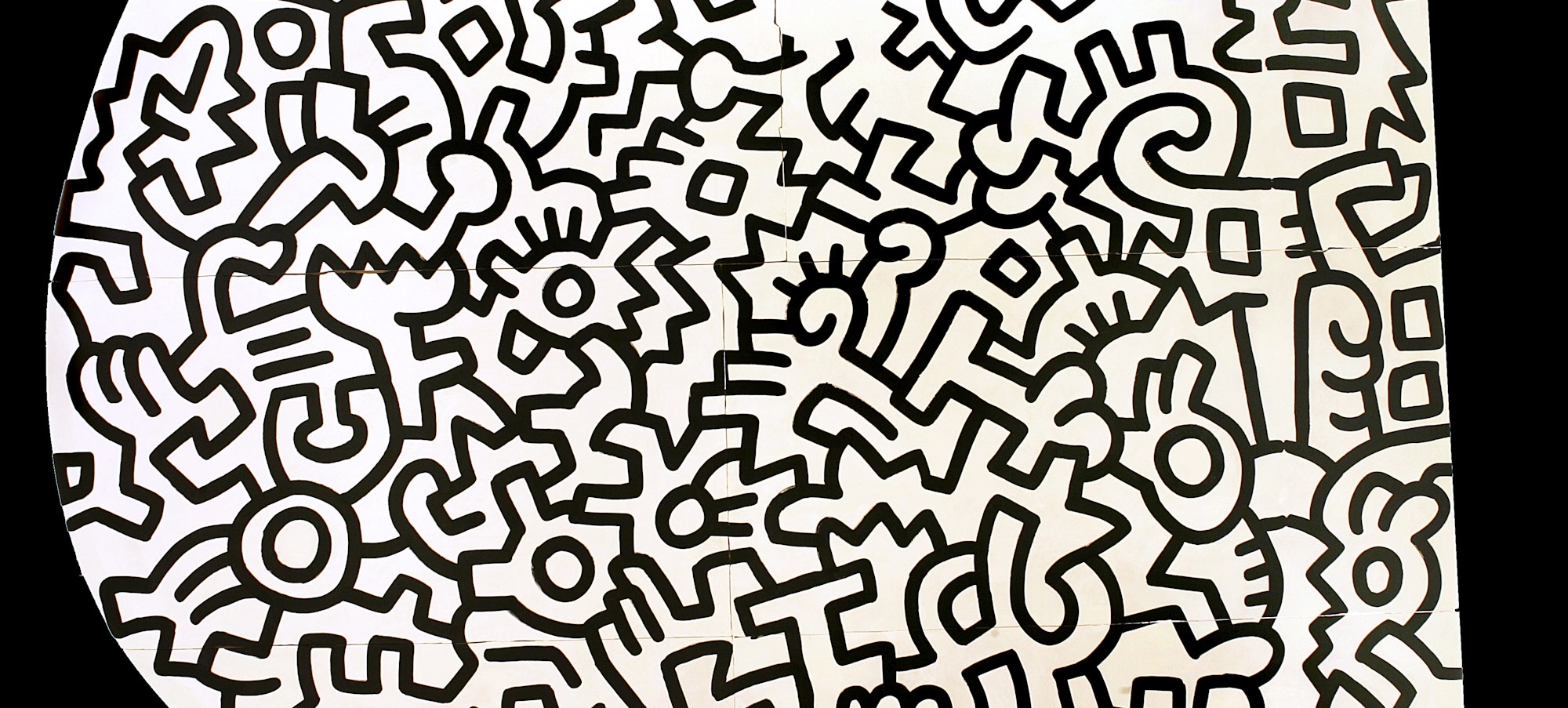 a section of Keith Haring's Pop Shop ceiling featuring his signature forms in black and white
