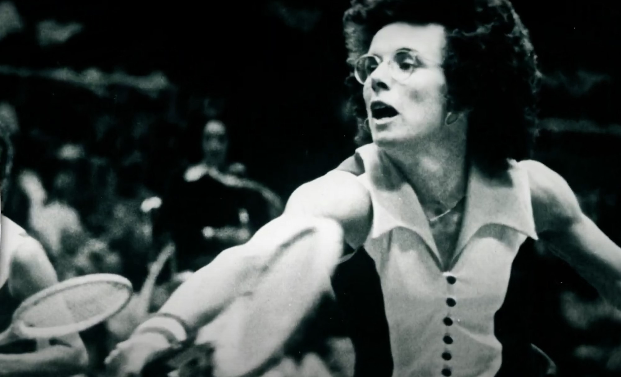 screen shot of Billie Jean King playing tennis from a history minute video