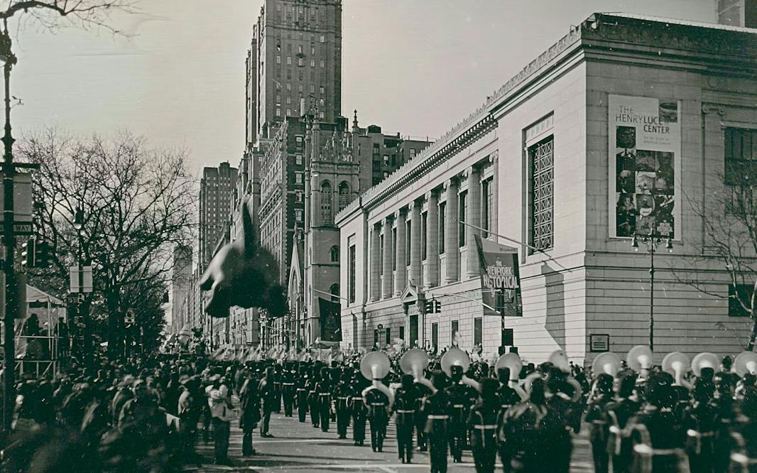 photo of the Macy's Thanksgiving Parade going down Central Park West in front of the New York Historical with a marching band in the foreground and a balloon in the distance.Jerry Spagnoli (born 1956), Macy's Thanksgiving Day Parade, 2000. Daguerreotype. Patricia D. Klingenstein Library Collection, The New York Historical.