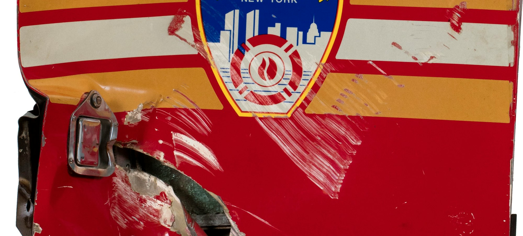 Front door from a FDNY fire truck that was damaged during the Sept. 11 attack
Saulsbury Fire and Rescue (1960-2004), Damaged front door of Rescue Company 2 rig, ca. 2001. Stainless steel, paint. The New York Historical, Gift of the Fire Department of New York City, 2002.50.2