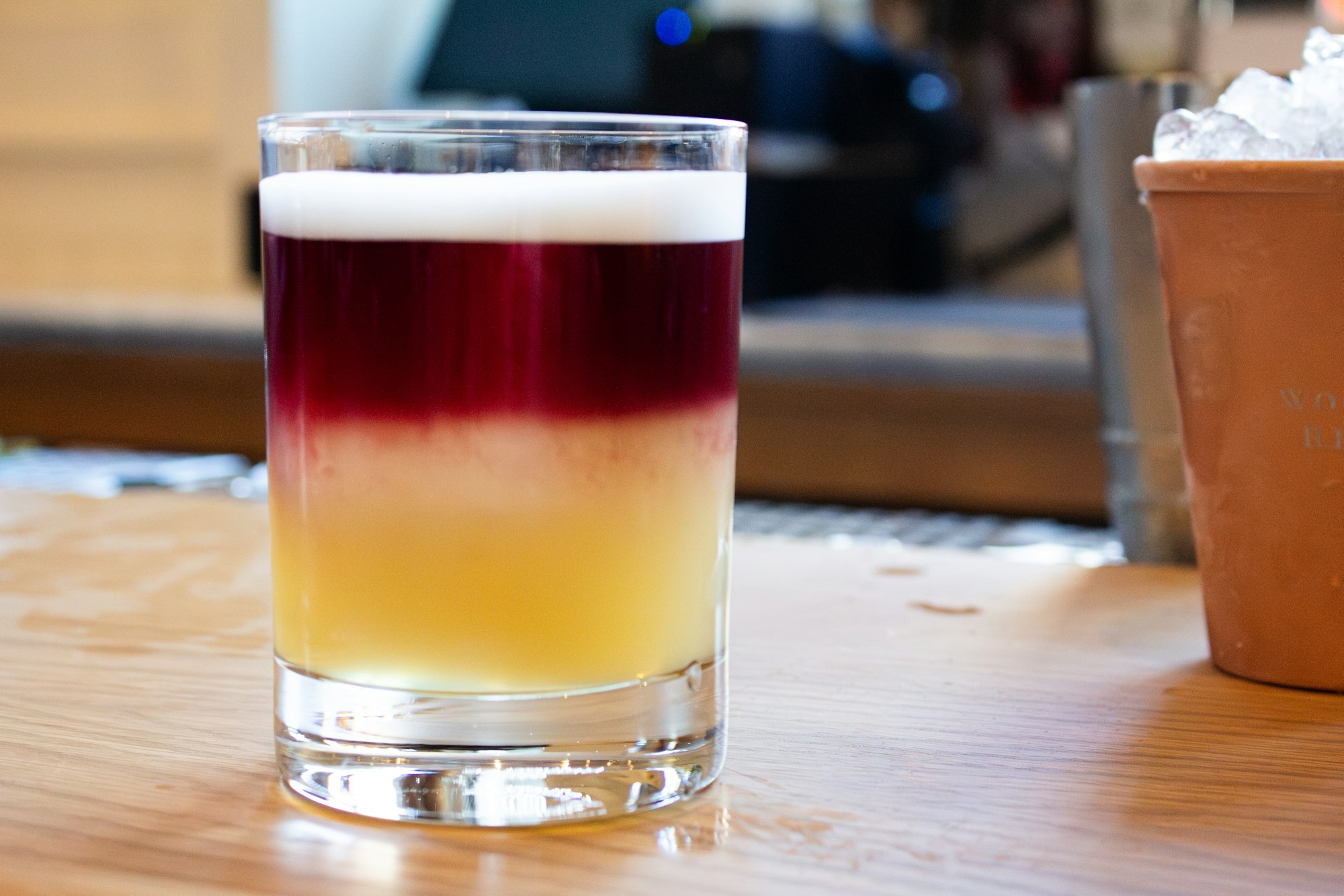 a cocktail in a rocks glass sitting on the bar of Clara