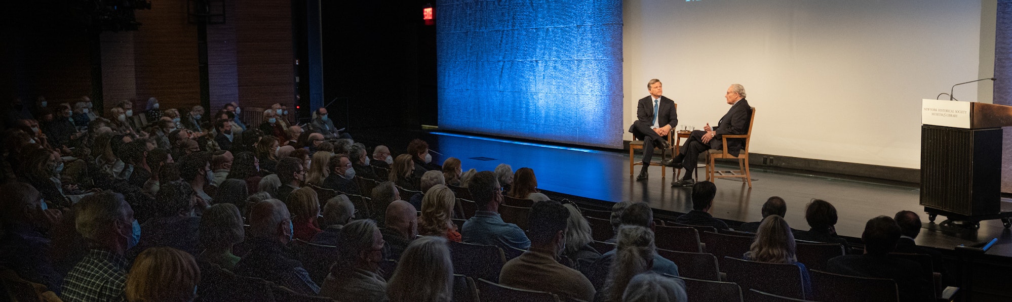Douglas Brinkley and Robert Caro on stage in the auditorium before a crowd for the symposium in 2021