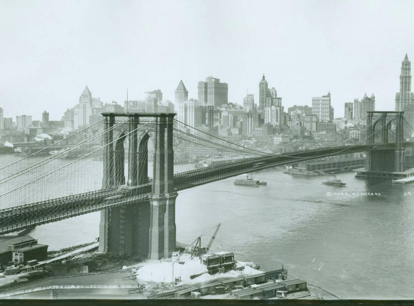 old black and white image of a bridge entering NYC