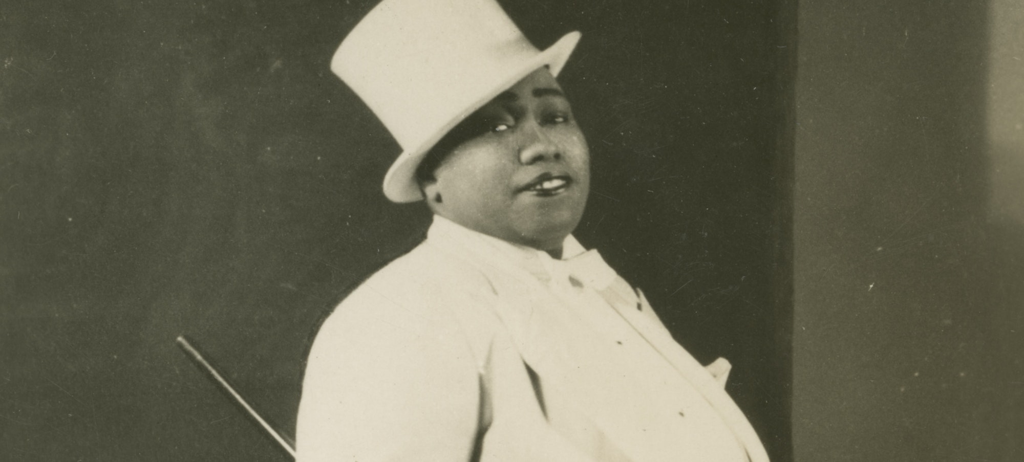 Unidentified photographer, Gladys Bentley, 1946-1949, a Black drag performer wearing a white tuxedo and top hat. Gelatin silver print. Collection of the Smithsonian National Museum of African American History and Culture