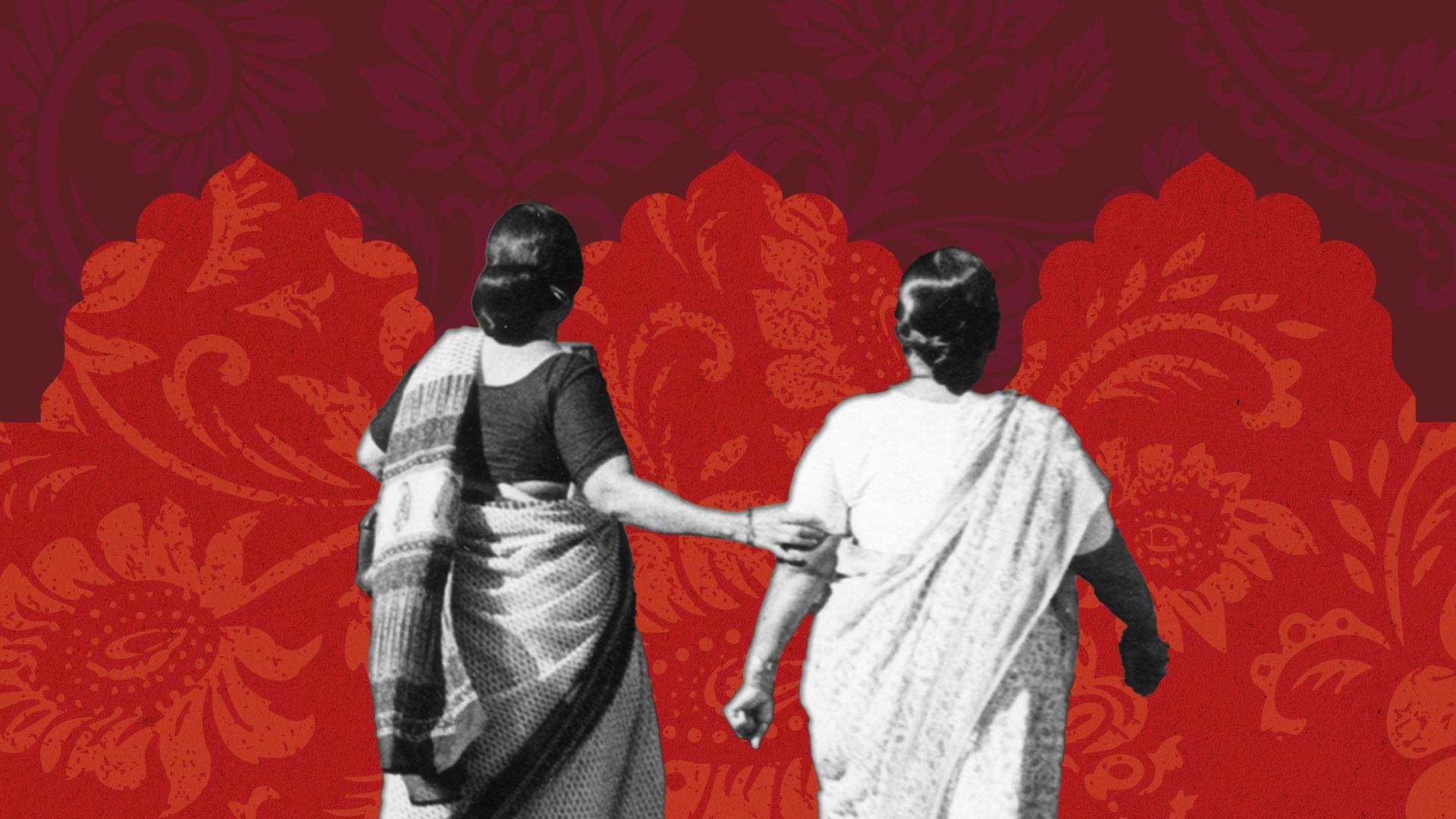 two women in saris from behind against a colorful red backdrop
