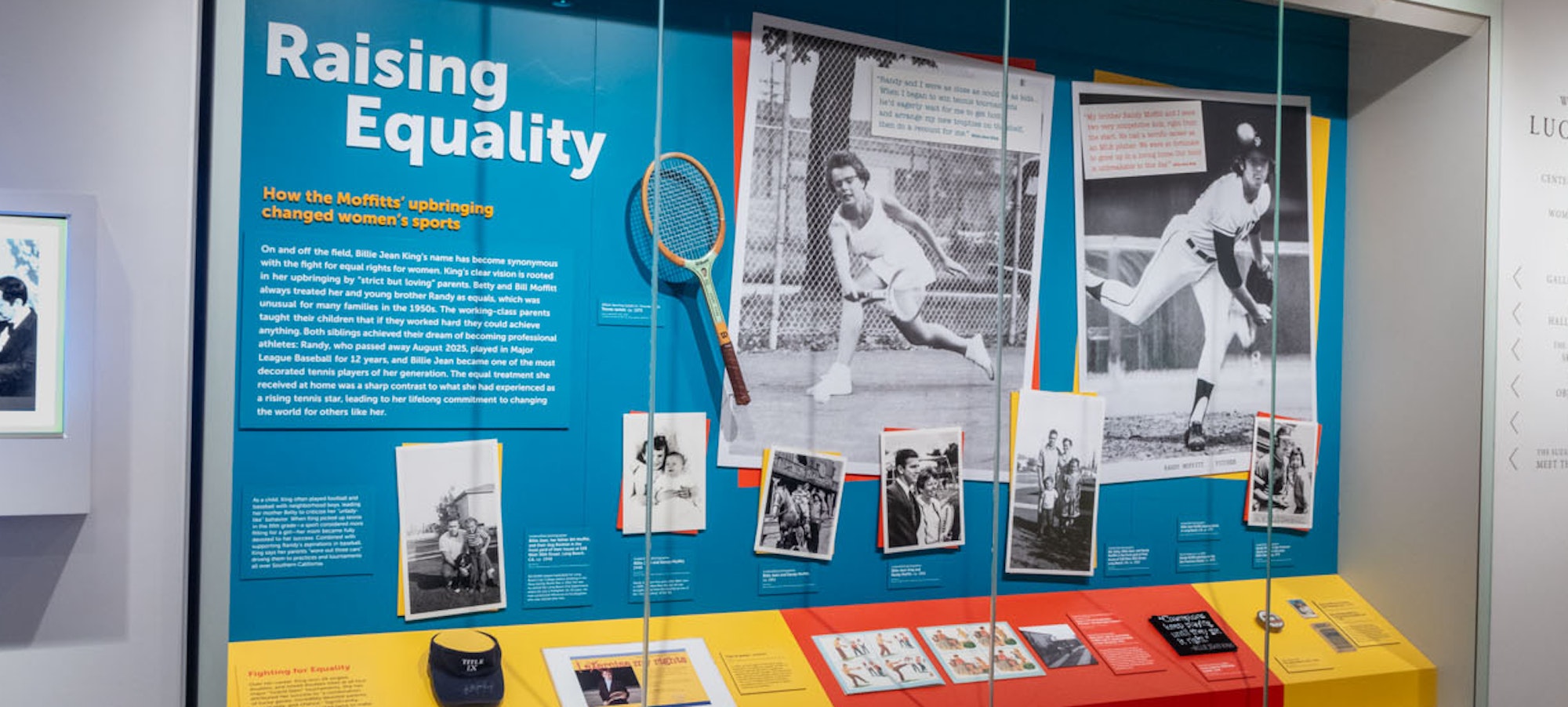 installation shot of the Raising Equality installations, showing photographs and ephemera from Billie Jean King's childhood