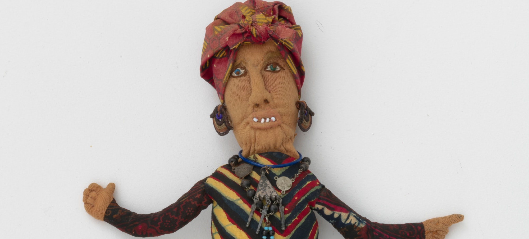A Betye Saar artwork of a hoo doo woman made of mixed fabric, leather, metal, and beads. Betye Saar (b. 1926), Hoo Doo Woman, 1974. Mixed fabrics, metal jewelry, leather, beads. Courtesy of the artist and Roberts Projects Los Angeles, California. Photo: Robert Wedemeyer