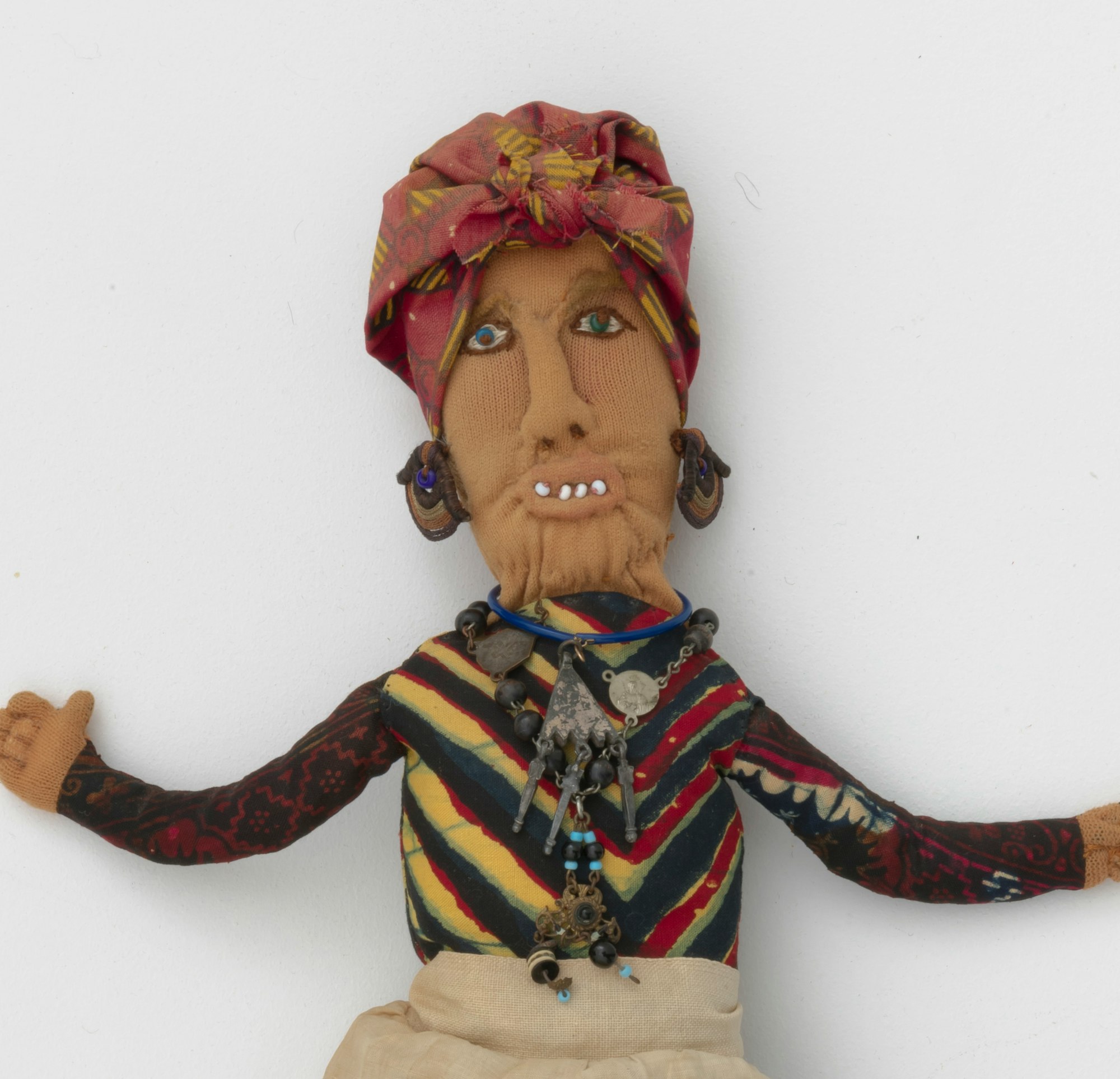 A Betye Saar artwork of a hoo doo woman made of mixed fabric, leather, metal, and beads.
Betye Saar (b. 1926), Hoo Doo Woman, 1974. Mixed fabrics, metal jewelry, leather, beads. Courtesy of the artist and Roberts Projects Los Angeles, California. Photo: Robert Wedemeyer