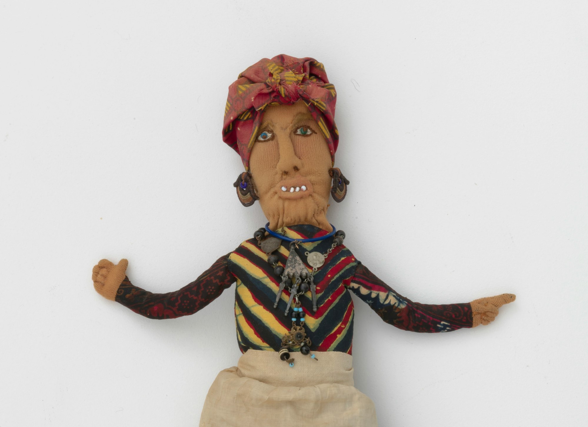 A Betye Saar artwork of a hoo doo woman made of mixed fabric, leather, metal, and beads.
Betye Saar (b. 1926), Hoo Doo Woman, 1974. Mixed fabrics, metal jewelry, leather, beads. Courtesy of the artist and Roberts Projects Los Angeles, California. Photo: Robert Wedemeyer