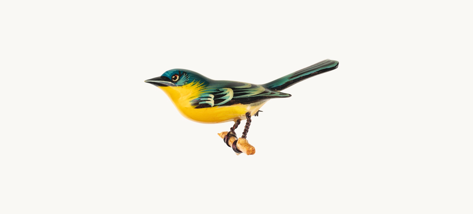 A small yellow and green bird pin crafted out of wood, wire, and metal.
Kiyoka Takahashi (Japanese-American, 1918-1994) and Yoneguma Takahashi (Japanese-American, 1909-2004), Female Northern Parula Warbler bird pin, 1942–1945. Wood, wire, paint, metal. The New York Historical, Gift of Carol Takahashi in Honor of her Grandparents Yoneguma and Kiyoka Takahashi, 2025.22.1