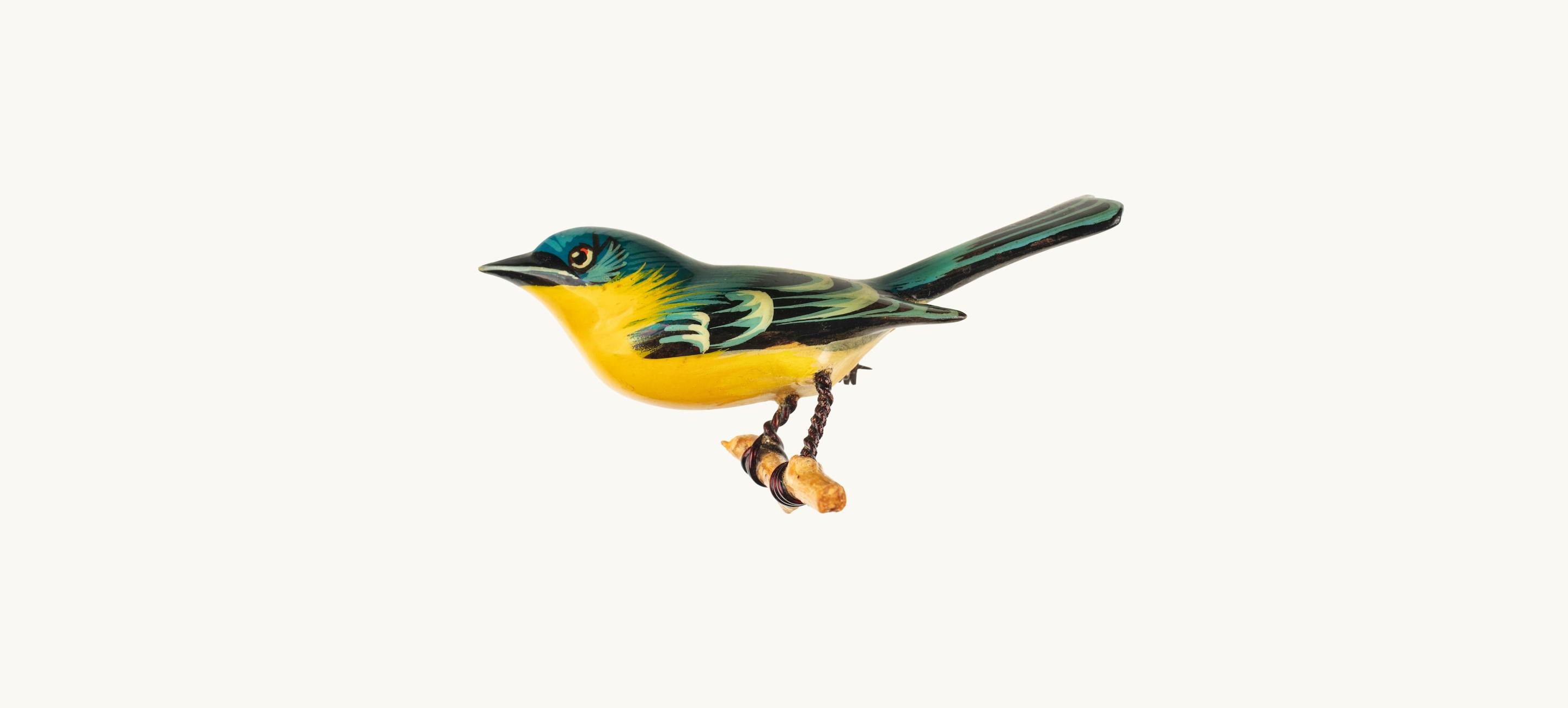 A small yellow and green bird pin crafted out of wood, wire, and metal.
Kiyoka Takahashi (Japanese-American, 1918-1994) and Yoneguma Takahashi (Japanese-American, 1909-2004), Female Northern Parula Warbler bird pin, 1942–1945. Wood, wire, paint, metal. The New York Historical, Gift of Carol Takahashi in Honor of her Grandparents Yoneguma and Kiyoka Takahashi, 2025.22.1
