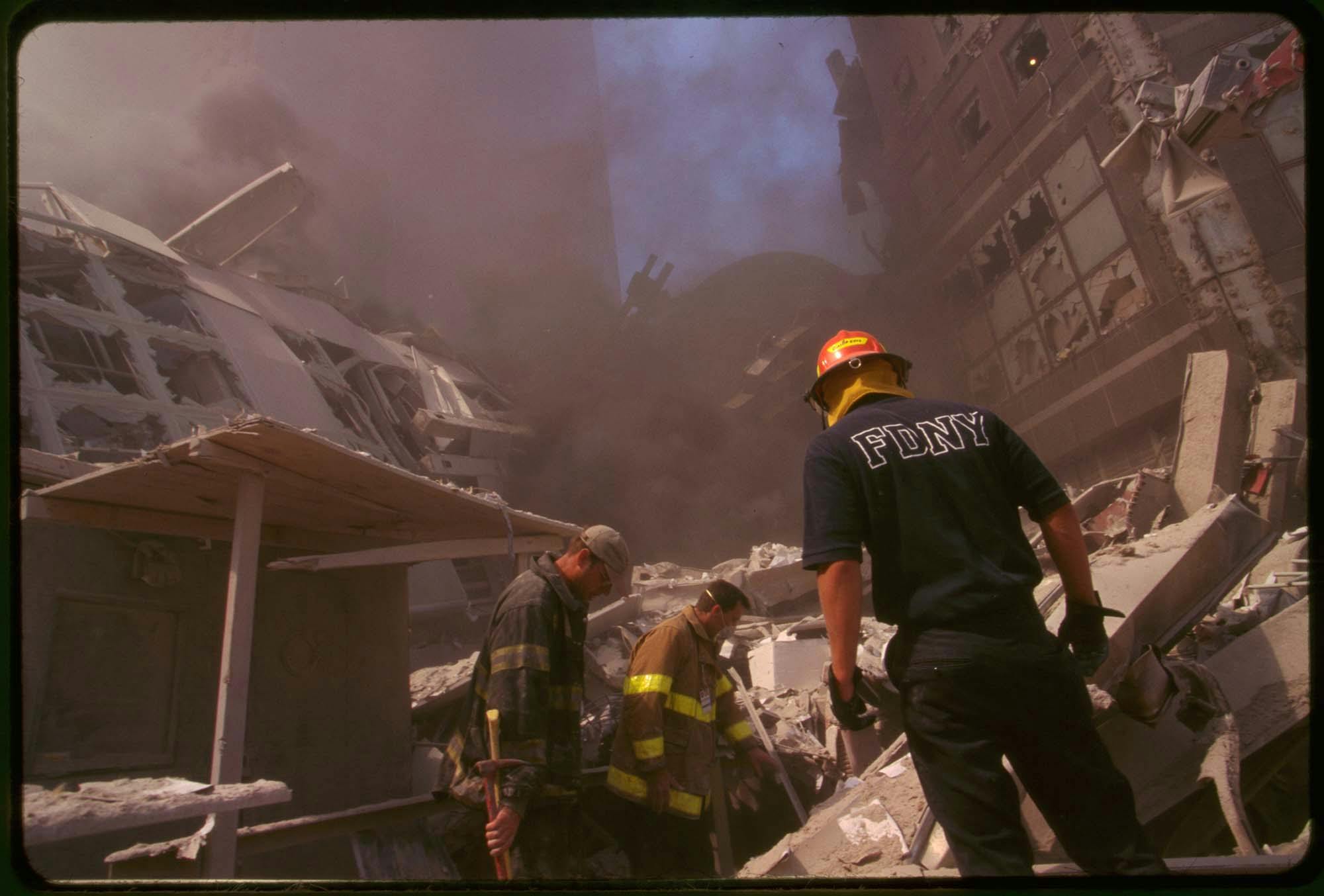 firefighters survey the wreckage downtown on 9/11