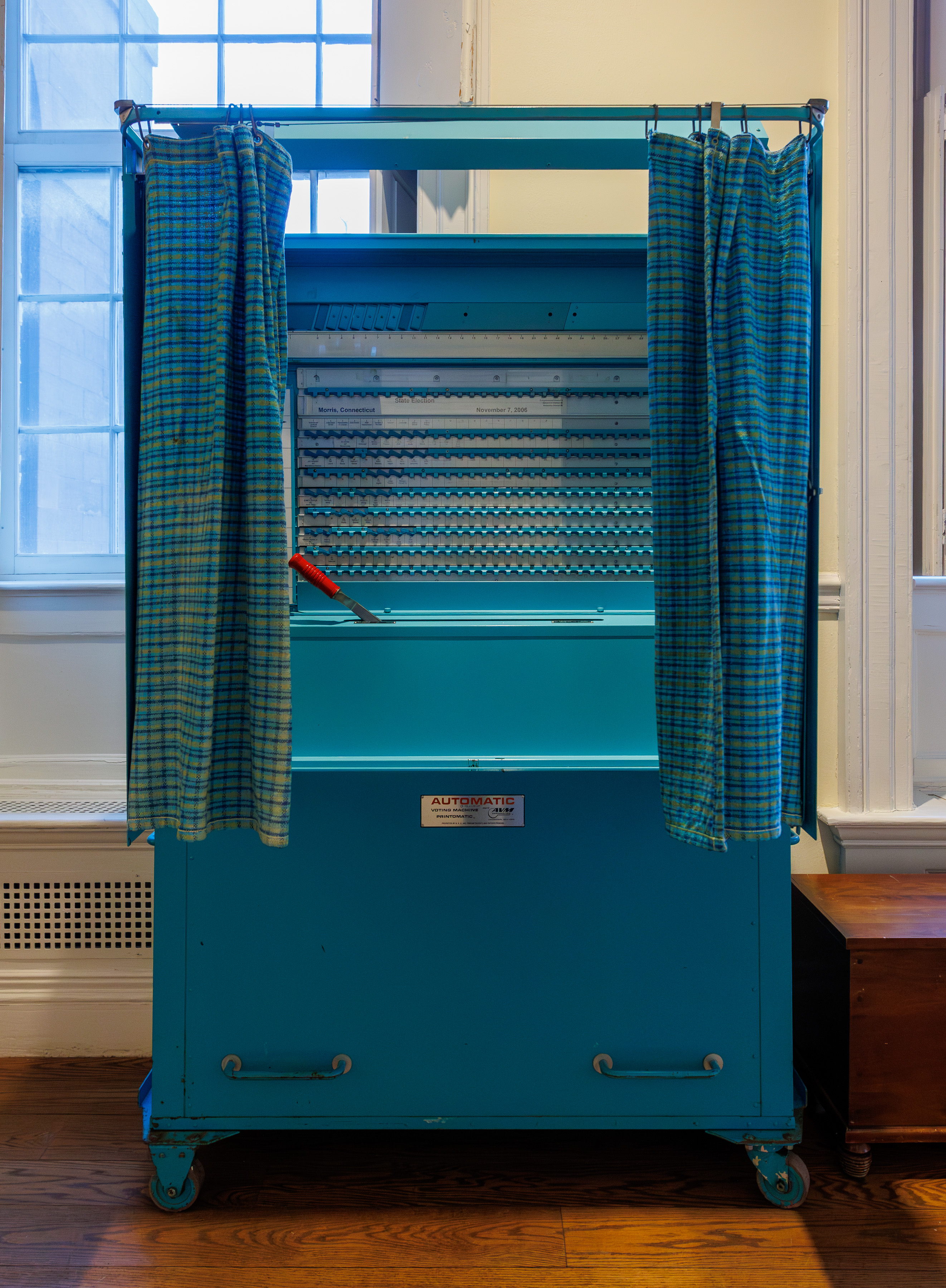 An older style voting booth with the curtains and levers, turquoise blue, in the Old State House, Hartford, Connecticut

Photo by: Kenneth C. Zirkel